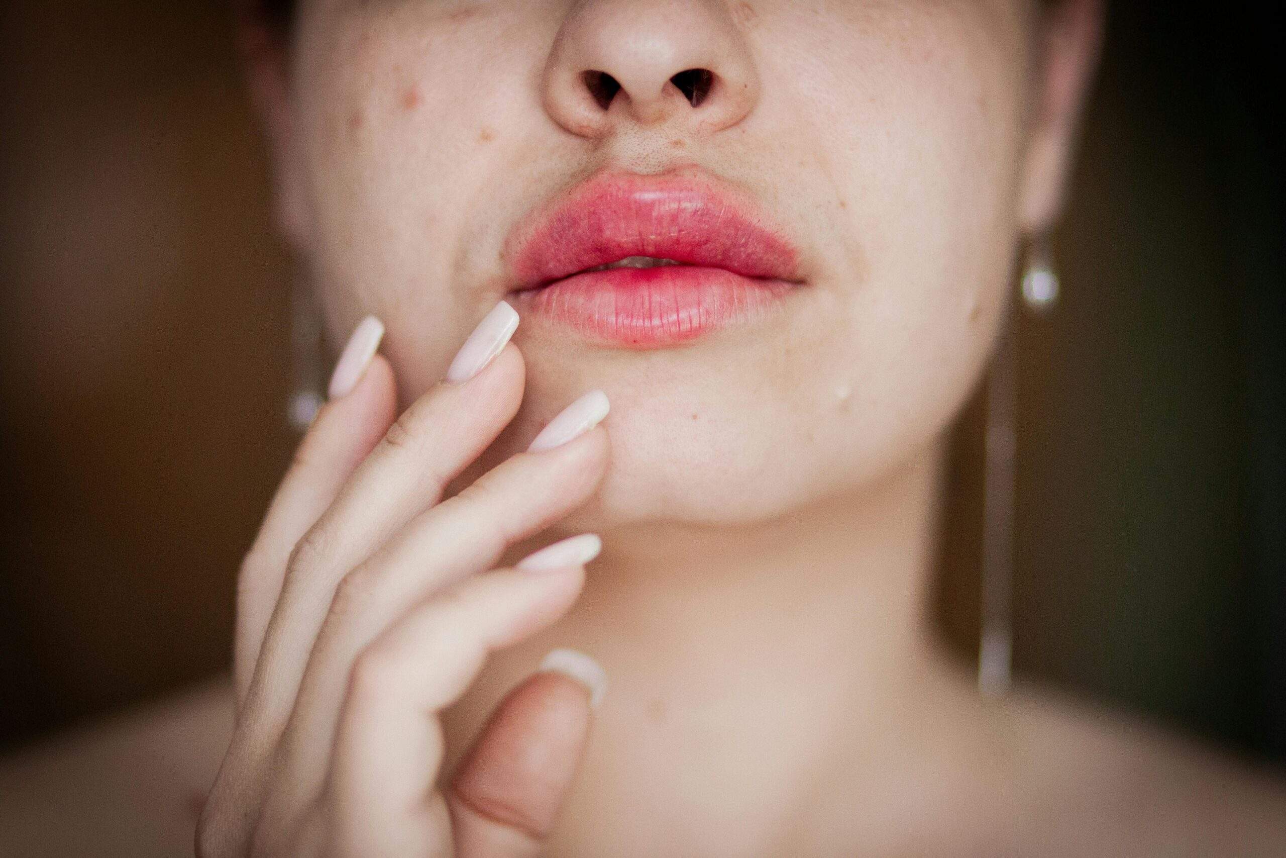 A model wearing soft smoky eyes, rosy cheeks, and nude lips in an elegant prom makeup style.