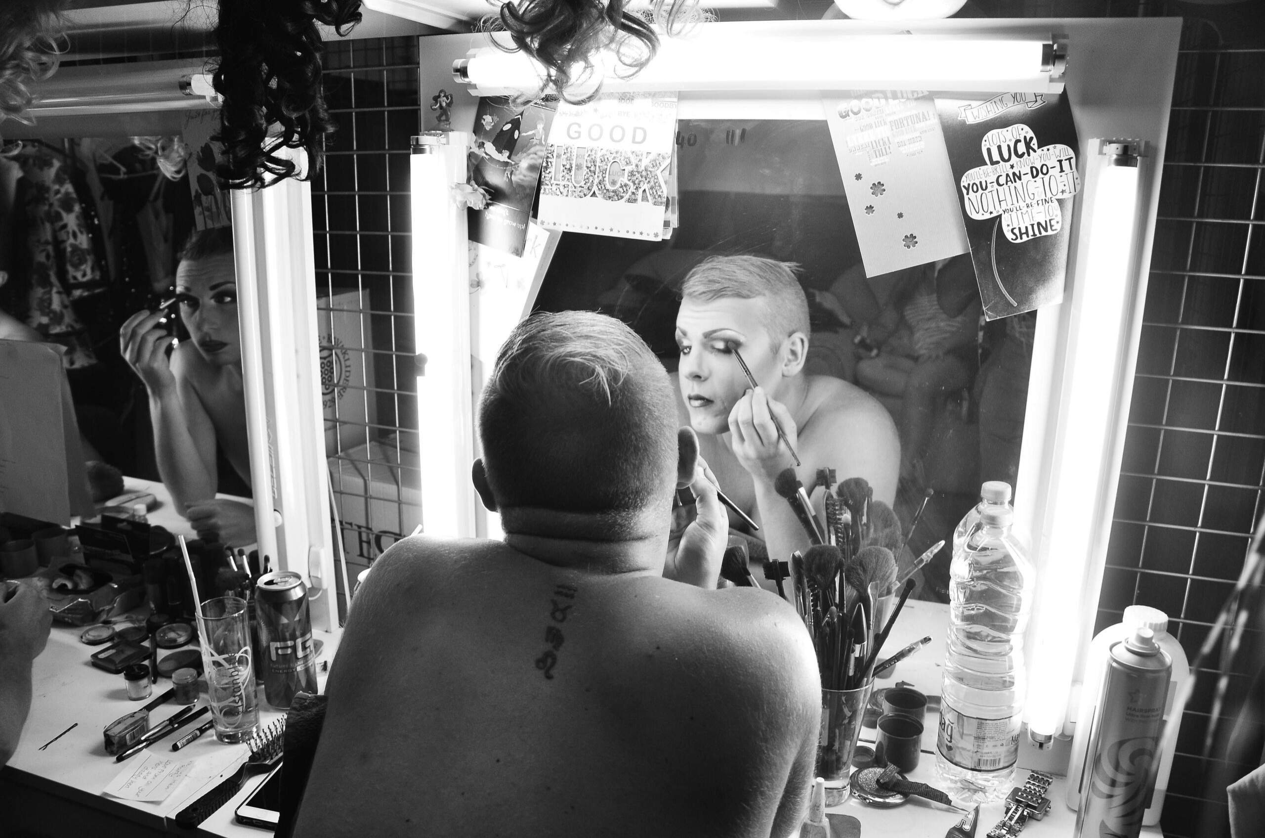 Makeup artist setting up brushes and palettes for evening glam demonstration