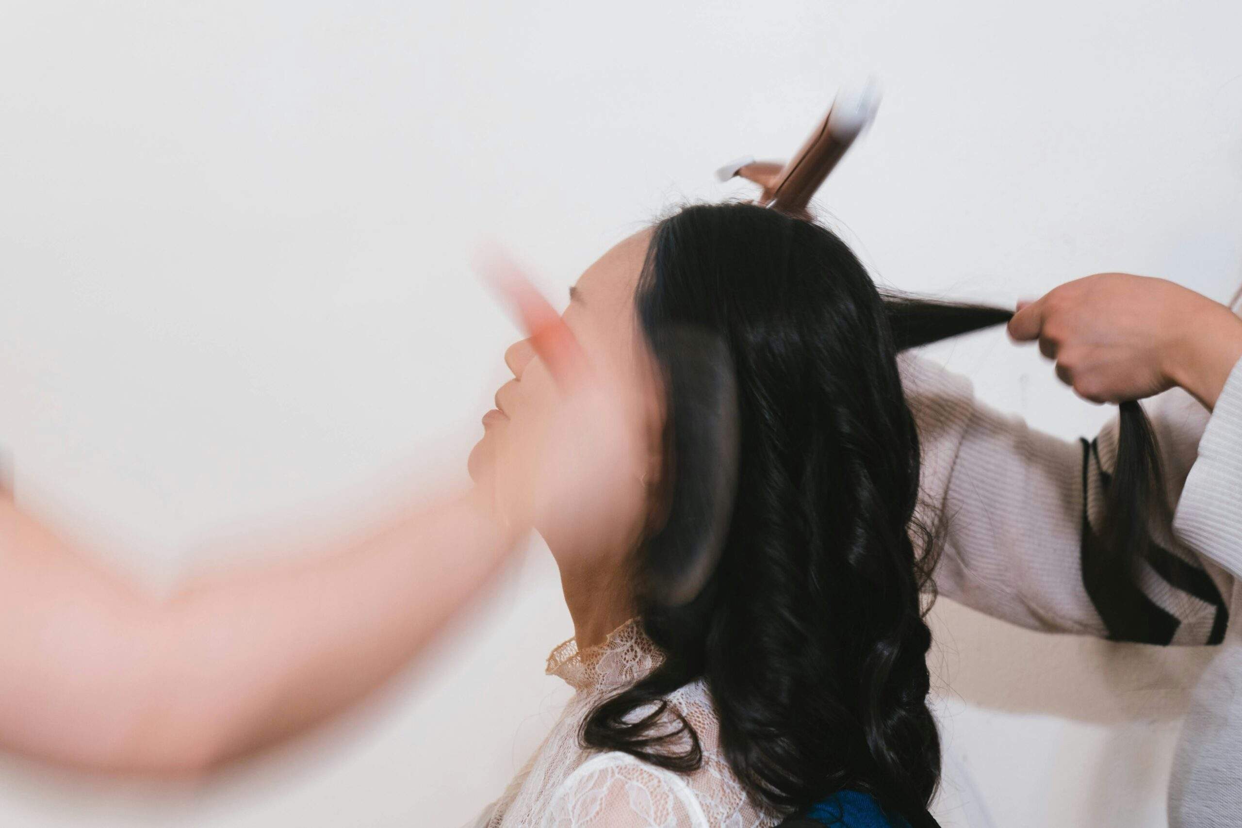 A teenager applying eyeliner before prom, surrounded by brushes and products