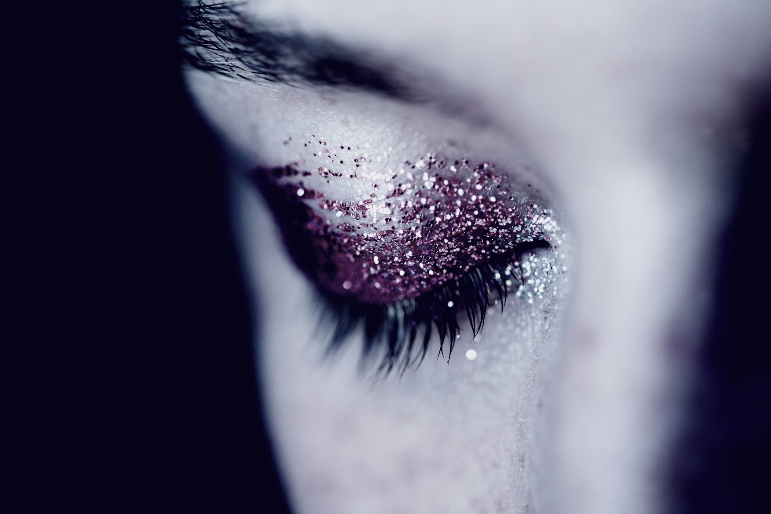 Closeup shot of glitter makeup being applied with minimal fallouts